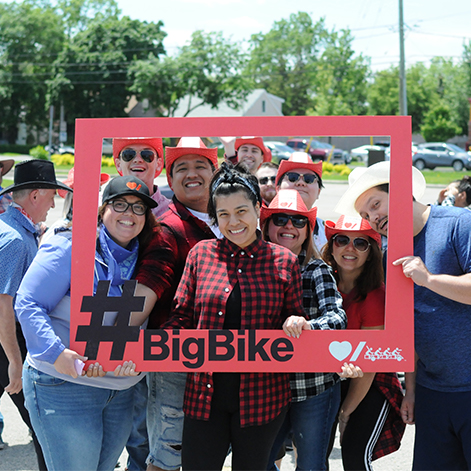 Group of employees smiling for Big bike challenge for Heart stroke non-profit organization.